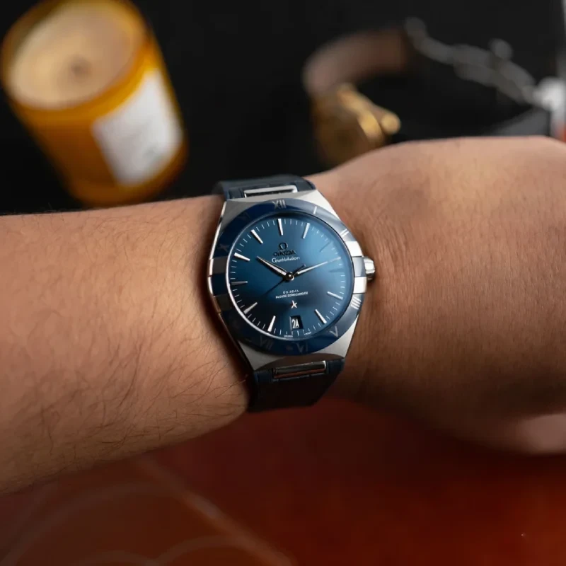 Omega-Constellation-on-wirst-blue.webp